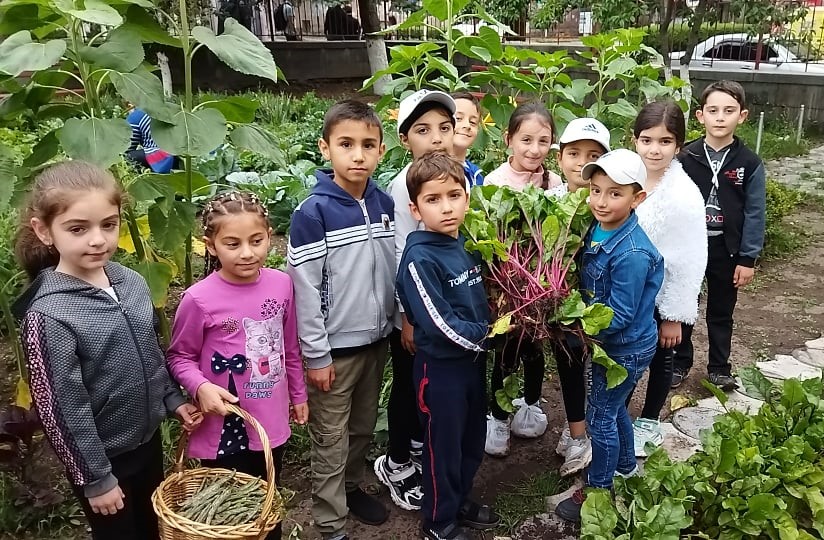 Kids with the harvest from their school garden.