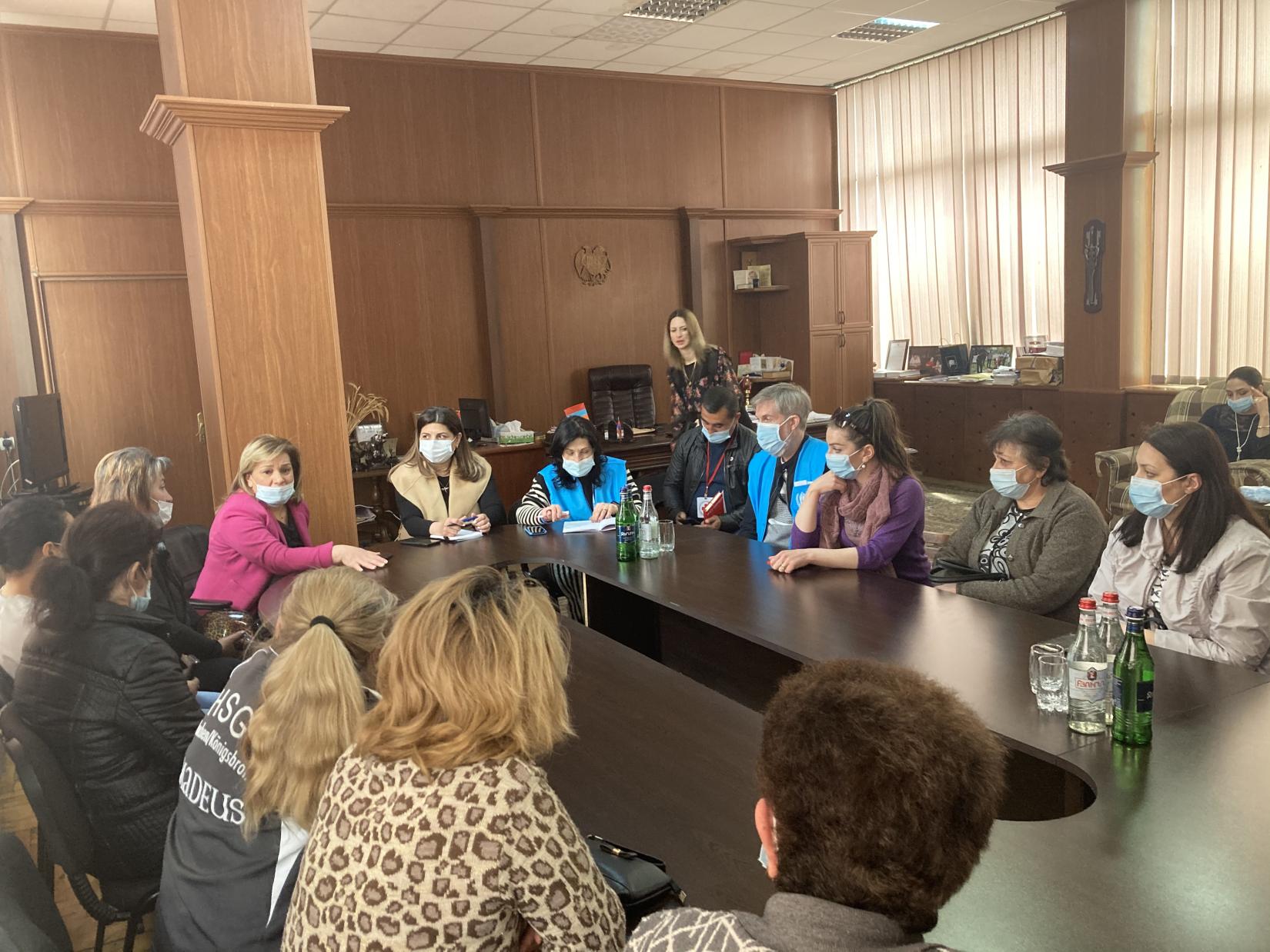 UNHCR staff at the meeting with a group of women displaced from NK.