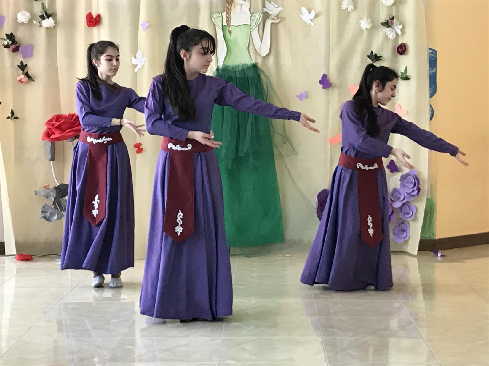 Three young girls from No. 1 secondary school in Metsamor dancing traditional Armenian dance