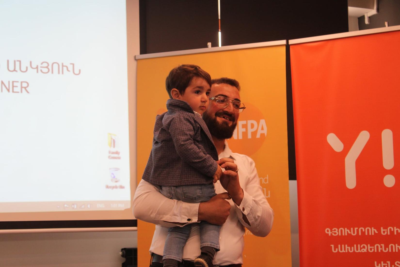 Garegin, participant of the "Caring for Equality" training, with his son.