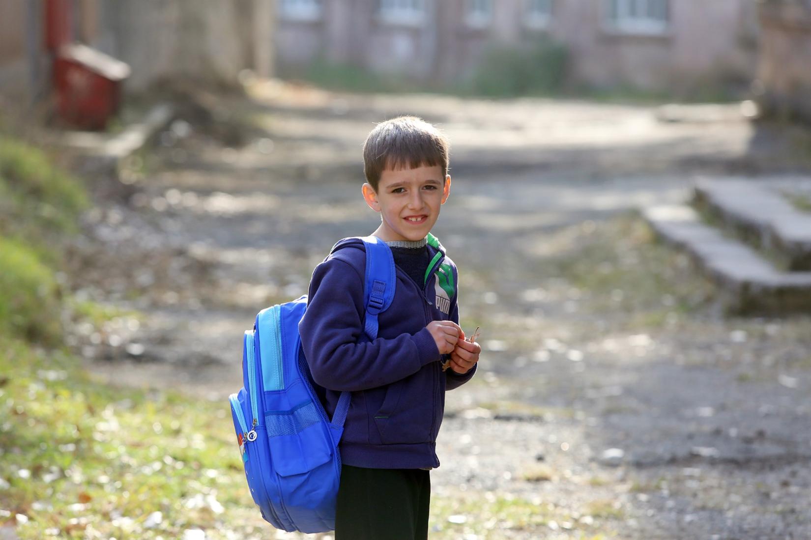 Boy with education kit provided by UNICEF.