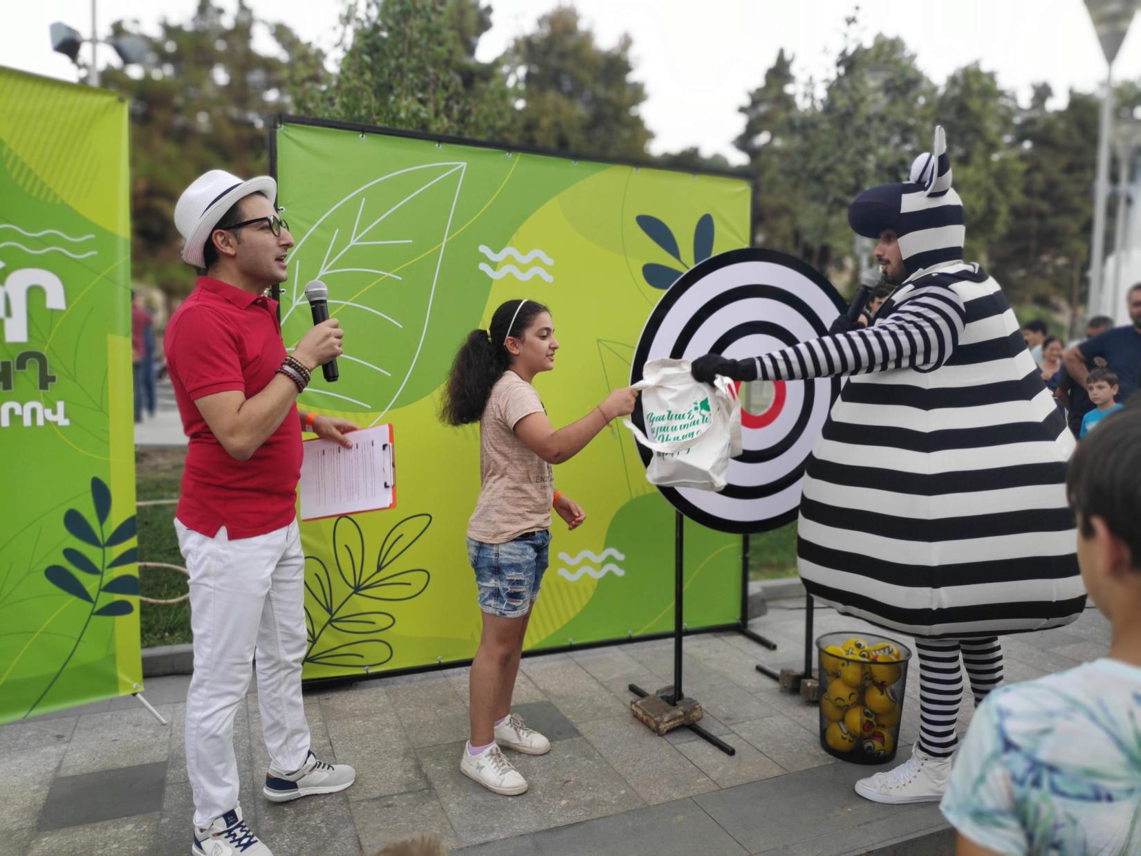 A girls receives a prize at the "Save the Planet SDGs" fun and educational Zebra Game.