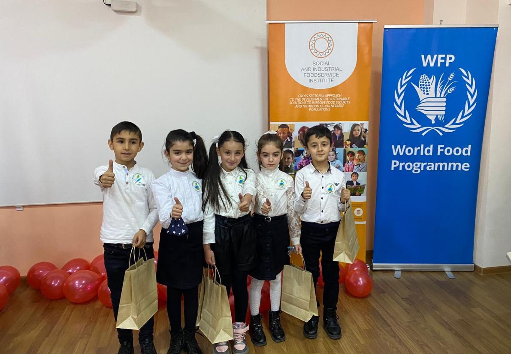 Schoolchildren with gifts from WFP.