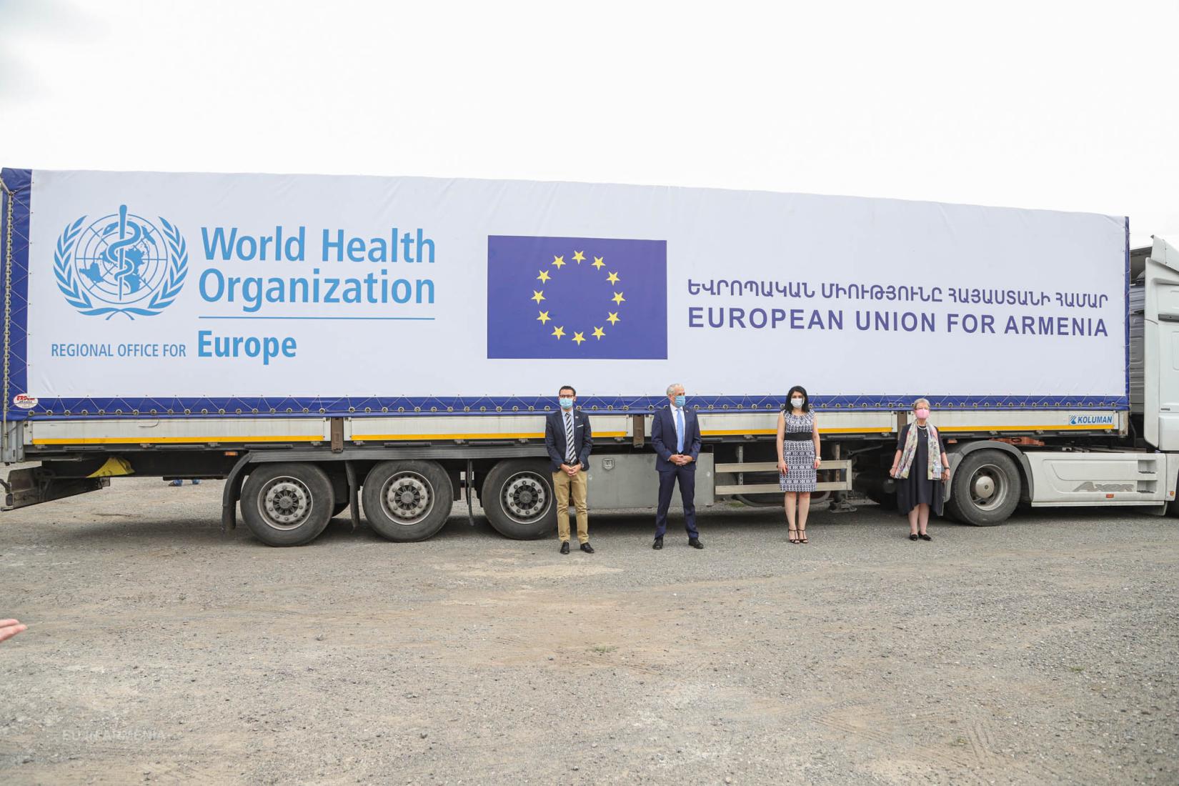 Vasily Esenamanov, Shombi Sharp, Lena Nanushyan and Andrea Wiktorin in front of the truck with the shipment.