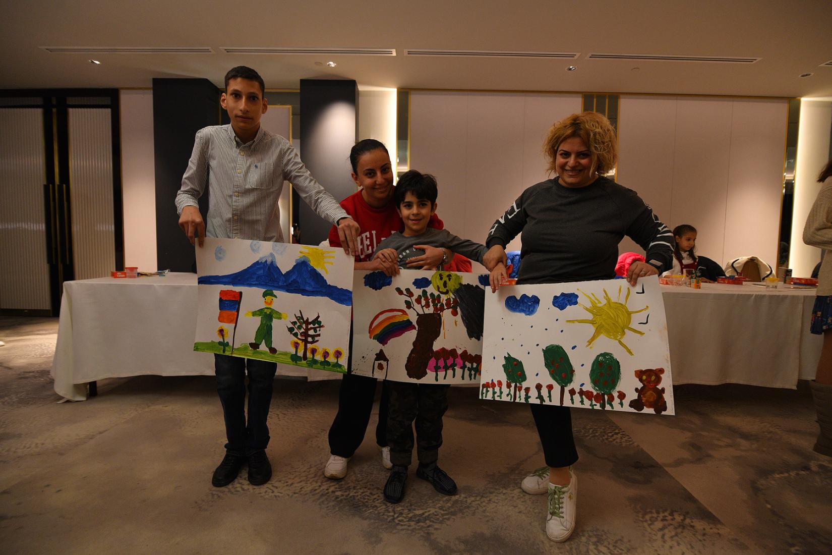 Kids show their artwork.