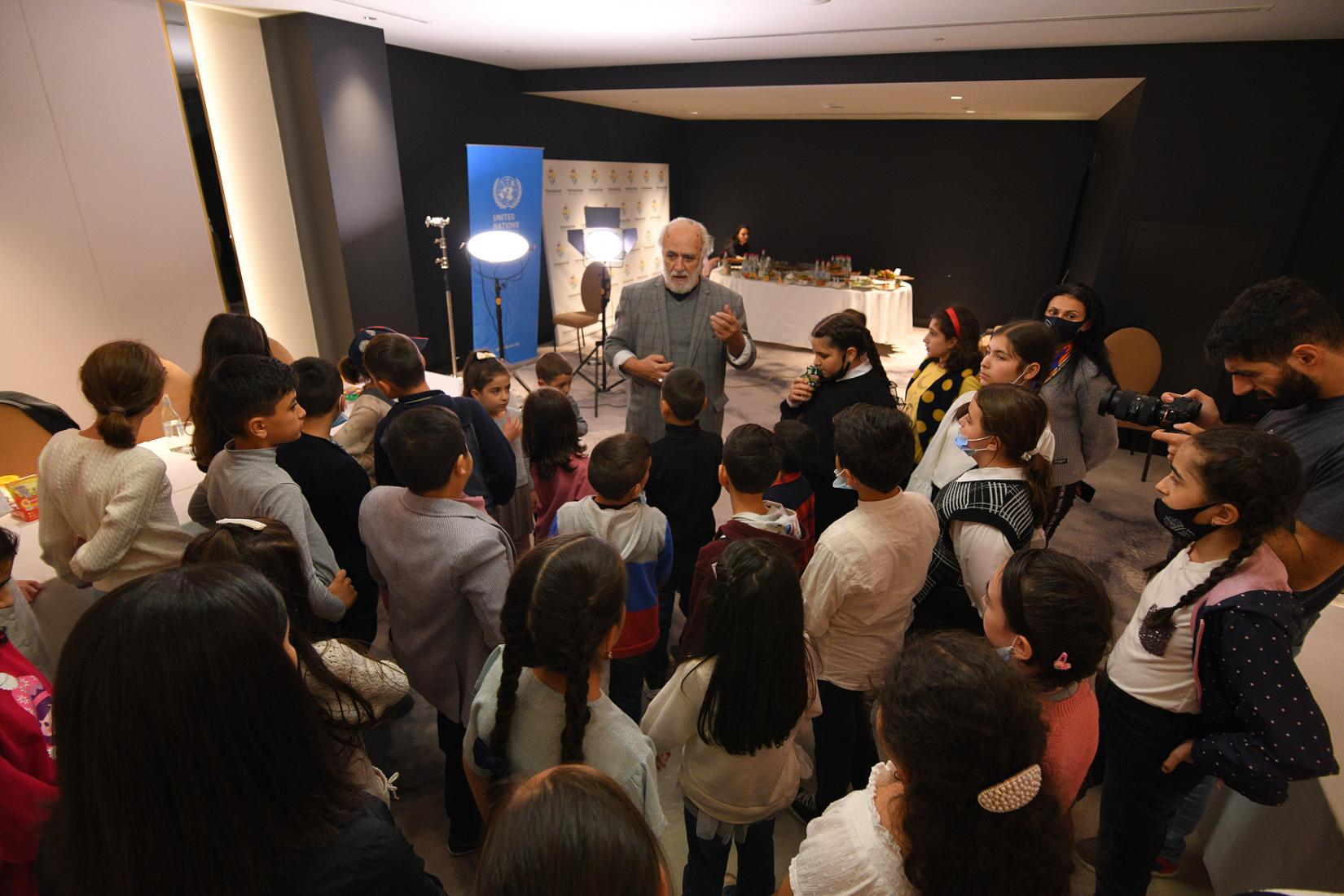Kids surrounded Samvel Sevada who gives useful tips to them.