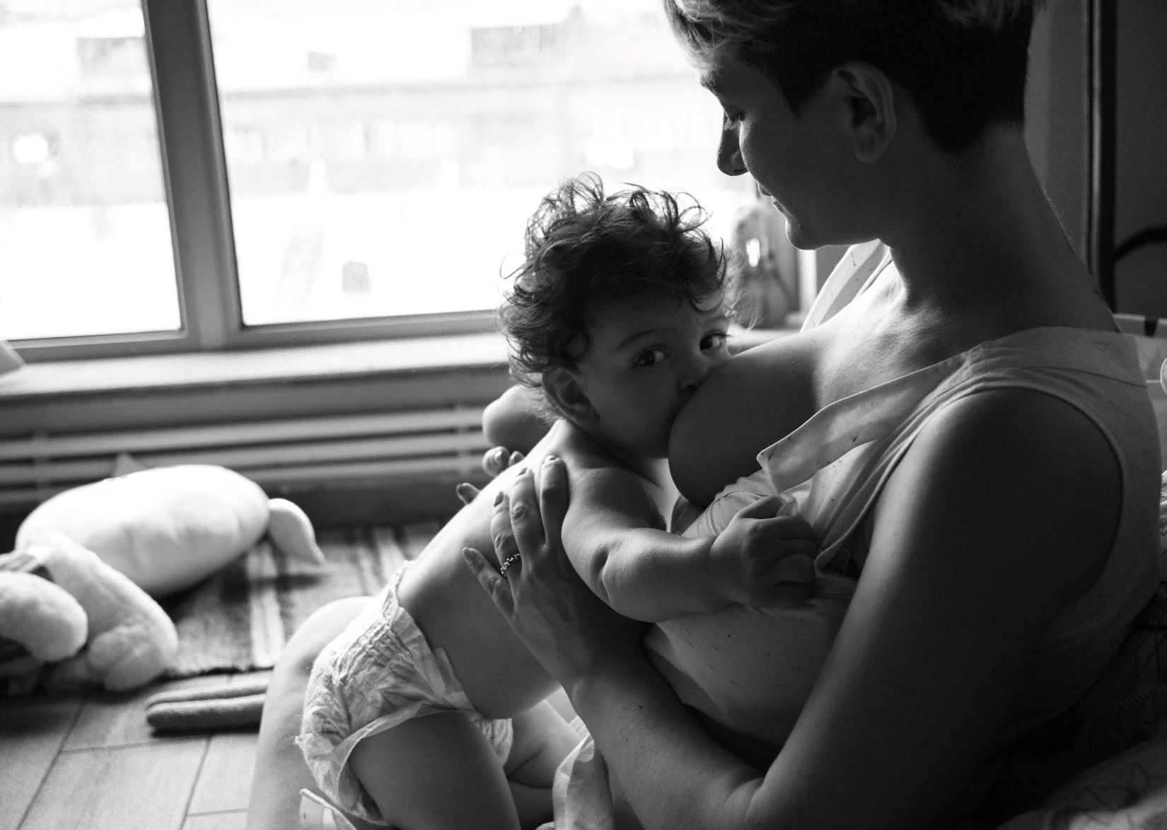 Woman breastfeeds a baby