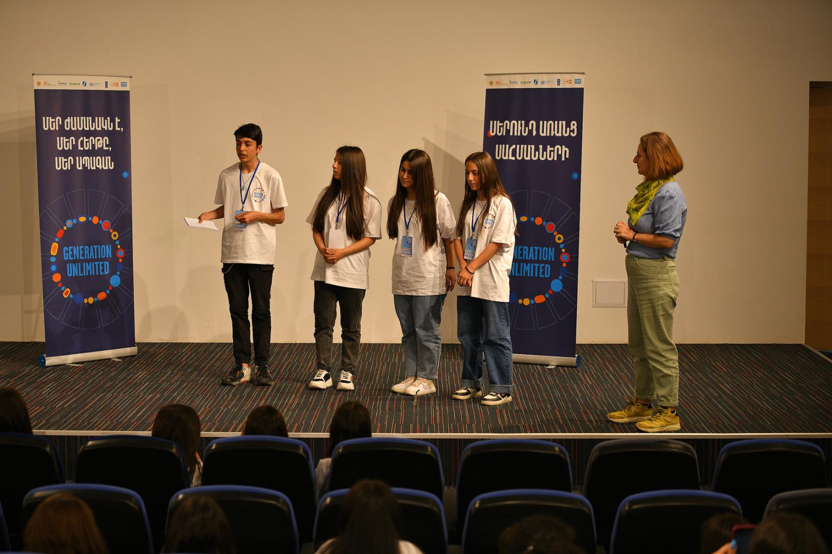 Four participants presenting their ideas to the mentor and other participants.