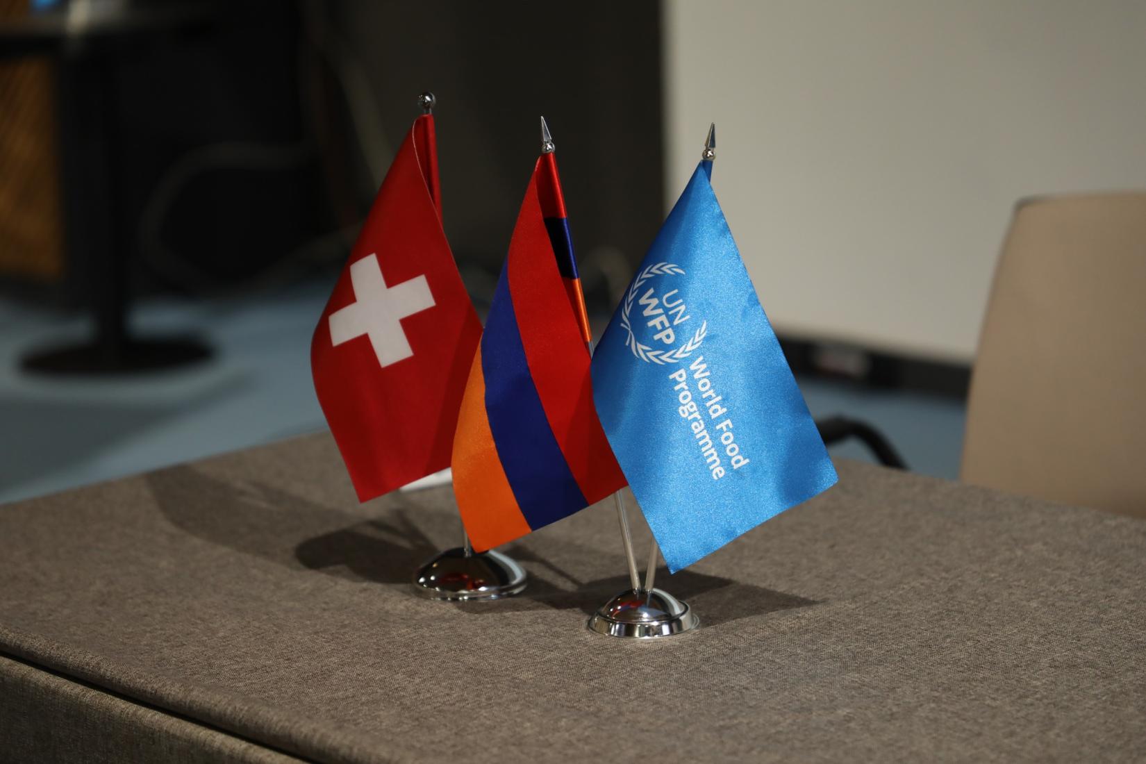 Flags of Switzerland, Armenia and WFP. 