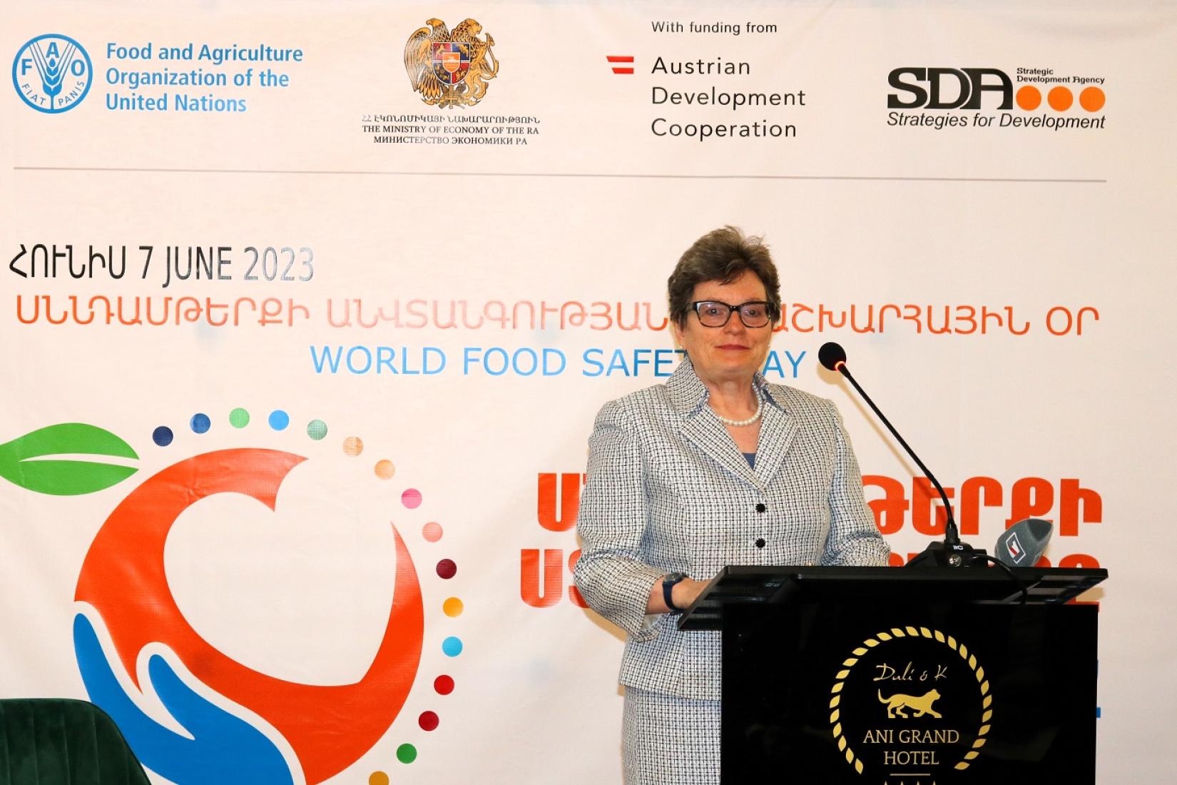 A female WHO official delivering a speech on World Food Safety Day.