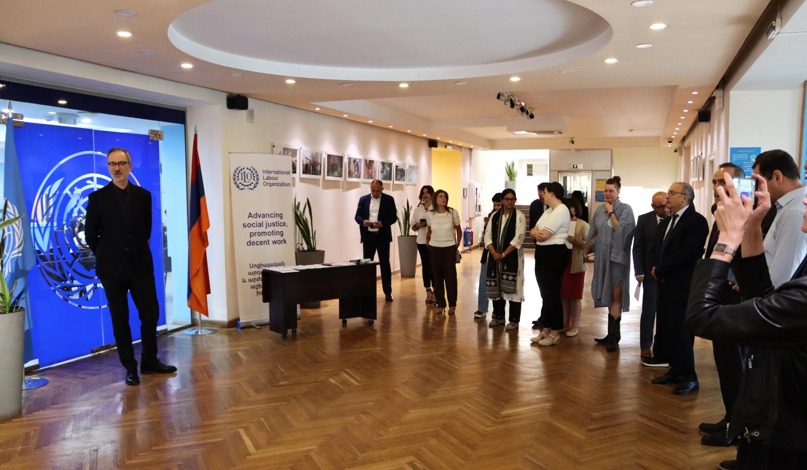 People attending a photo exhibition dedicated to the International Equal Pay Day.