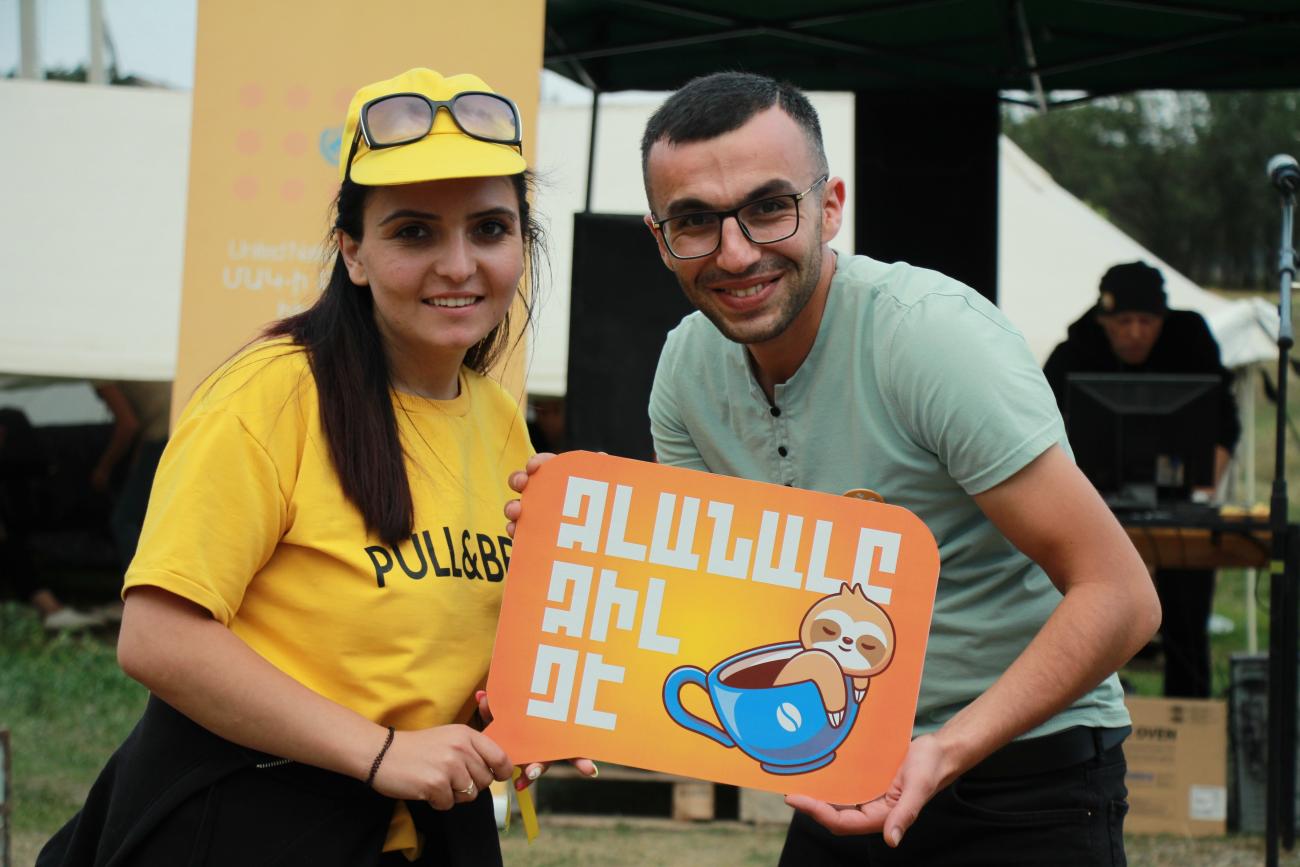 Participants of Youth Day in Lori holding the title of the celebrations saying "Idleness is not cool".