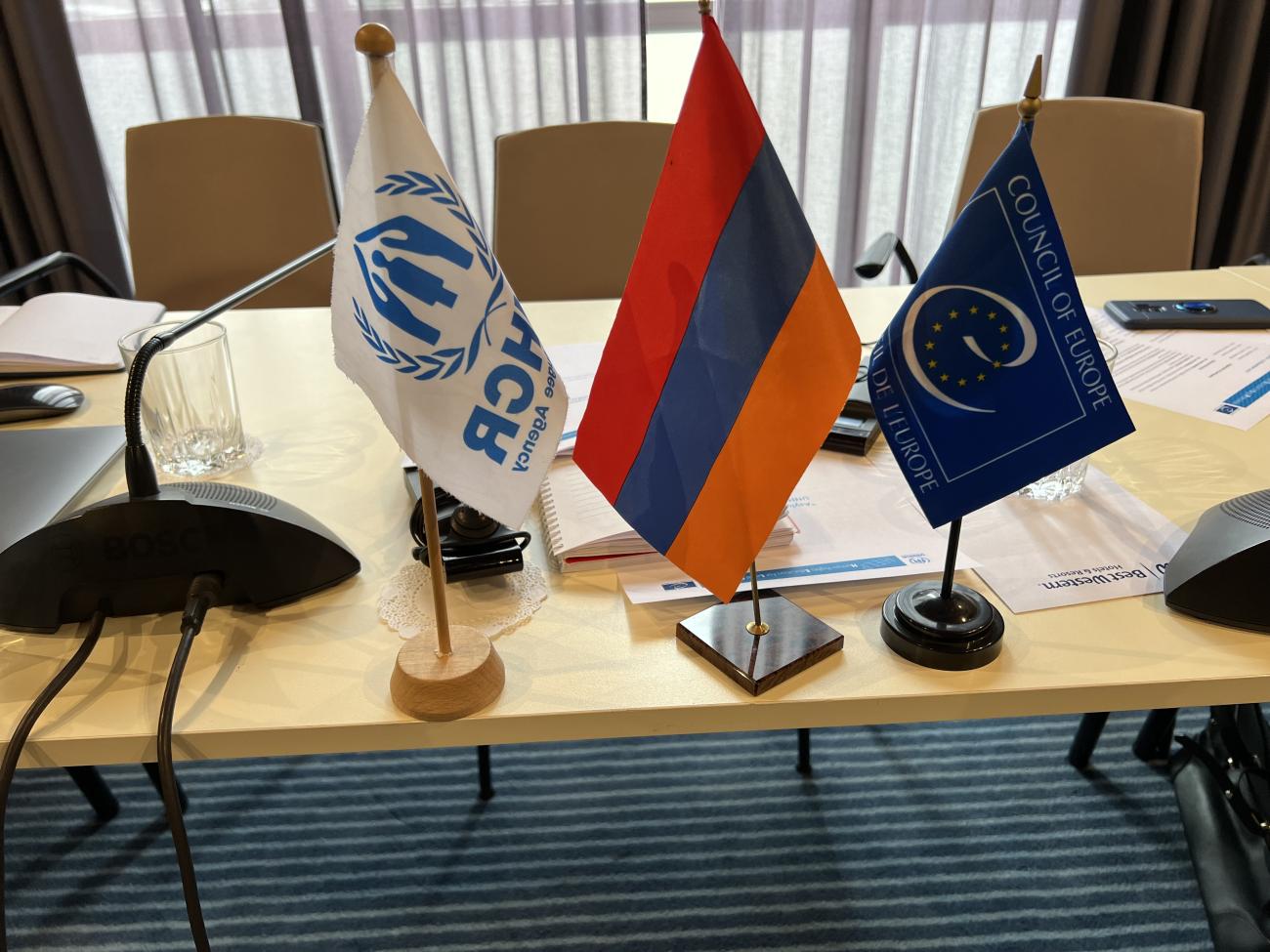 Flags of Armenia, UNHCR and CoE.