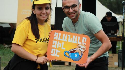 Participants of Youth Day in Lori holding the title of the celebrations saying "Idleness is not cool".