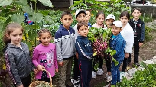 Kids with the harvest from their school garden.