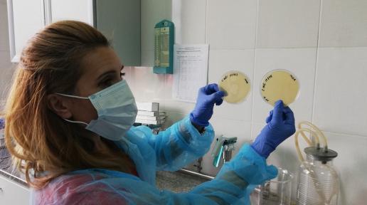 A lab worker shows analyzed samples. 