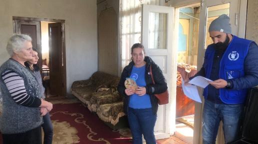 WFP representatives interviewing two adult women.