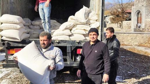 Four men carrying the emergency assistance.